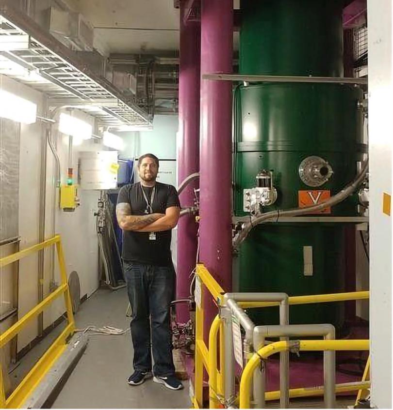 Aaron as a student next to the Nab spectrometer at ORNL